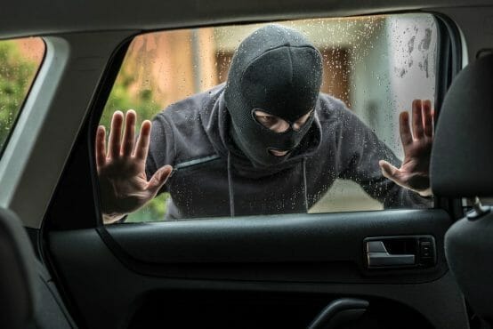 Car Thief Looking Through Car Window