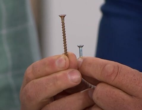 man holding a screw for a cylindrical locks