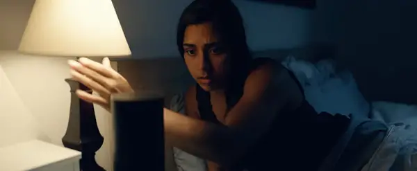 woman turning off her bed side lamp
