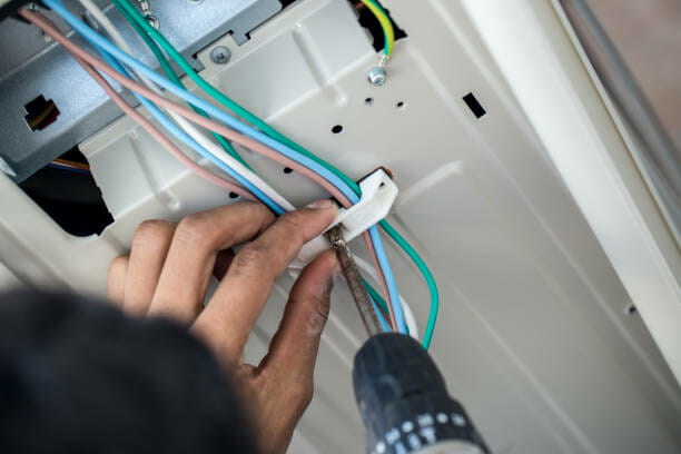 technician hand fixing wiring of security camera