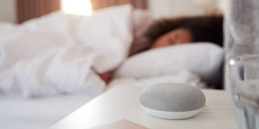 woman sleeping with alexa device on the sidetable