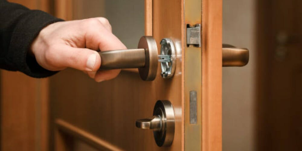 man's hand holding a doorknob