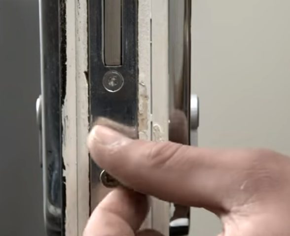 man unscrewing the lock