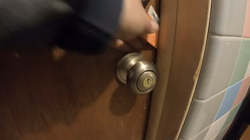 man inserting the plastic card to the door
